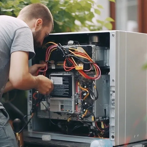 HVAC technician works on AC.